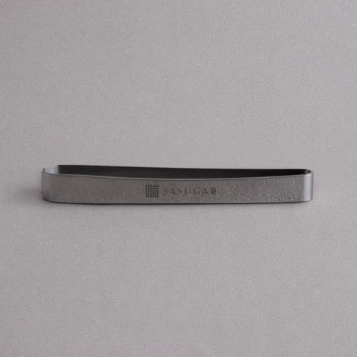 Metallic tool with 'SASUGA' branding on a gray background