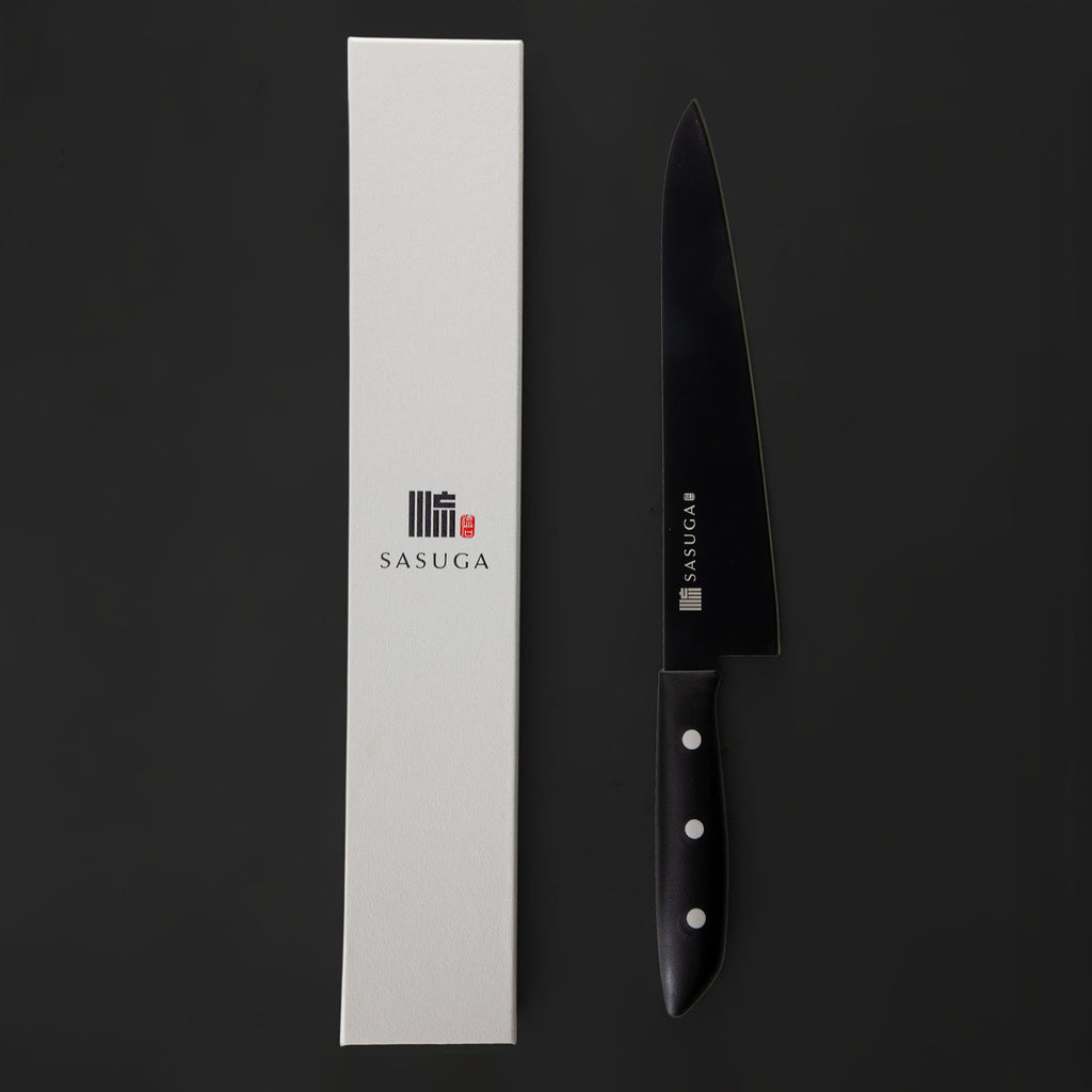 Black chef's knife with 'SASUGA' branding next to a white box on a black background