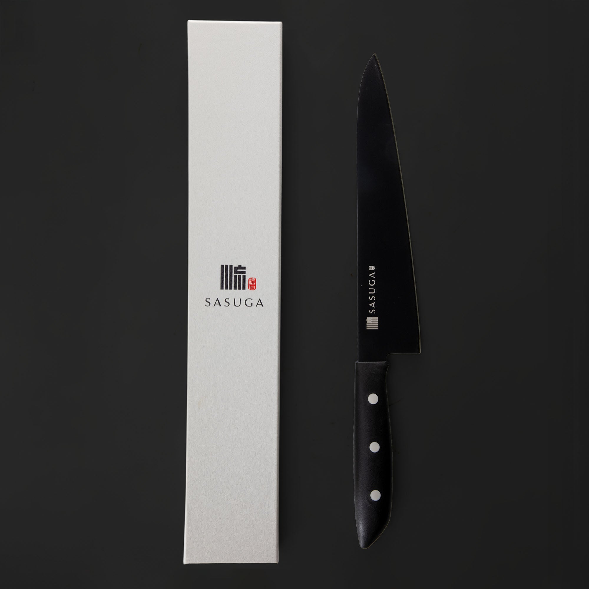 Black chef's knife with 'SASUGA' branding next to a white box on a black background