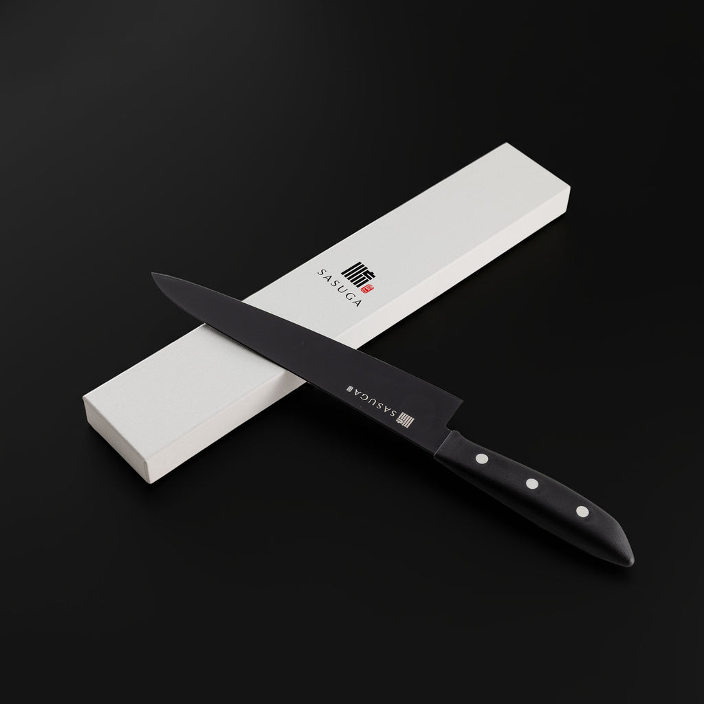 Black kitchen knife with a white blade on a black background