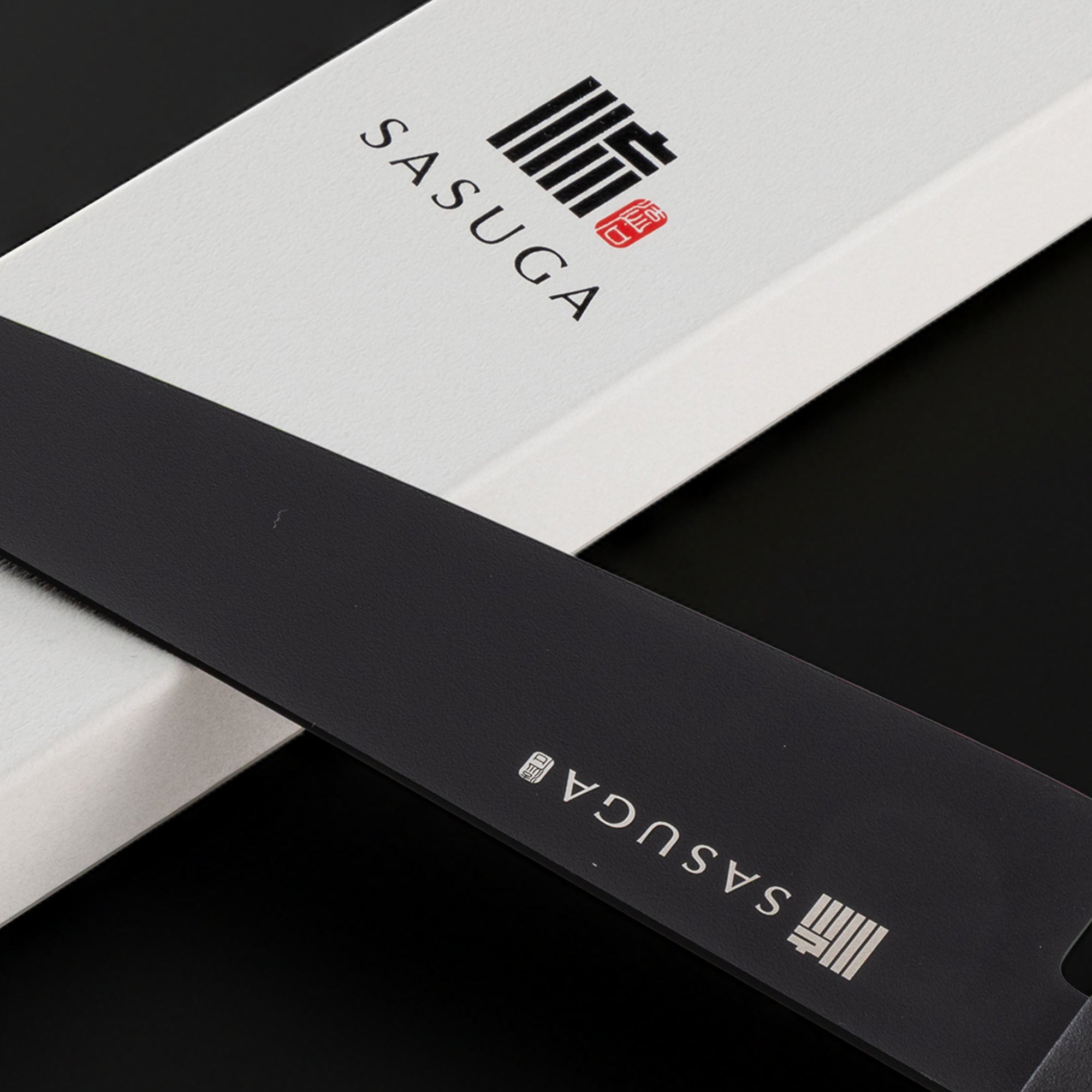 Close-up of a black and white product with 'SASUGA' branding.