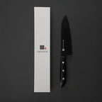 Black chef's knife with white handle next to a white box featuring the 'SASUGA' brand on a dark background.