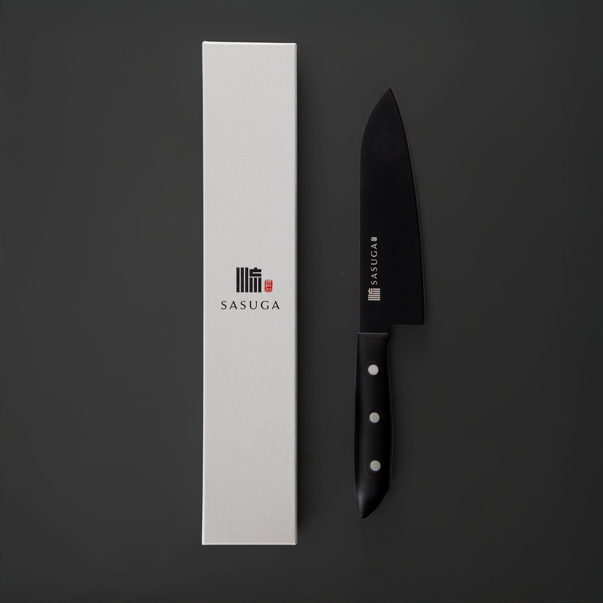 Black chef's knife with white handle next to a white box featuring the 'SASUGA' brand on a dark background.