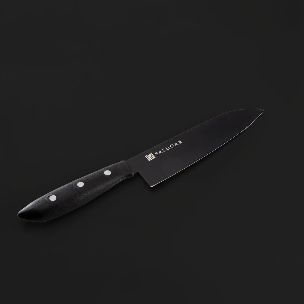 Black kitchen knife with a visible brand logo on a dark background